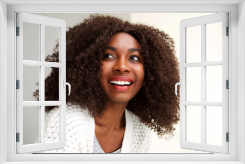 Close up happy young african woman looking away and smiling