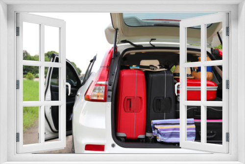 Fototapeta Naklejka Na Ścianę Okno 3D - Closeup of rear side of white car carry suitcases and other things for lovely family holiday in summer.