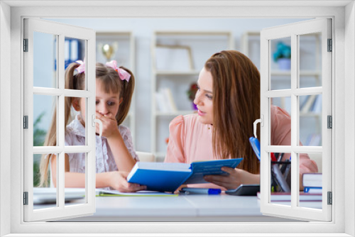 Mother helping her daughter to do homework