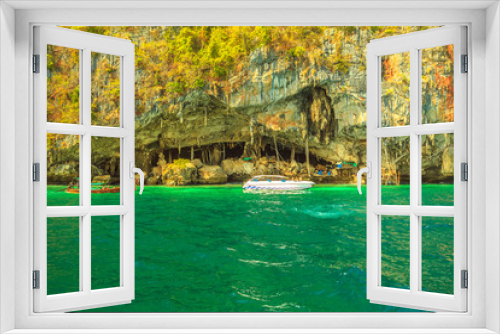 Fototapeta Naklejka Na Ścianę Okno 3D - Boats visit Viking Cave, north of Piley Bay, one of main tourist attractions of Ko Phi Phi Leh, near Maya Bay, Phi Phi Islands, Thailand. Inside the cave, there are thousands of nestles of swifts.
