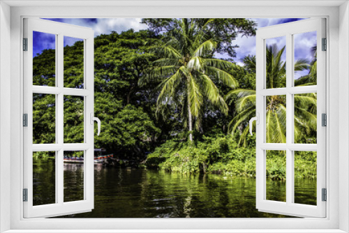 Fototapeta Naklejka Na Ścianę Okno 3D - Colorful Tour Boat Parked at an Island with Tropical Palm Trees at the Isletas de Granada in Granada, Nicaragua