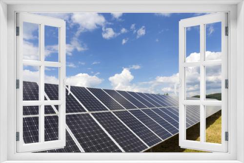 Fototapeta Naklejka Na Ścianę Okno 3D - Solar Power Station on the spring Meadow with cloudy Sky 