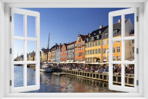 Fototapeta Naklejka Na Ścianę Okno 3D - COPENHAGEN, DENMARK - AUGUST 26: Unidentified pedestrians walk past beautiful buildings in Copenhagen, Denmark on August 26, 2016.