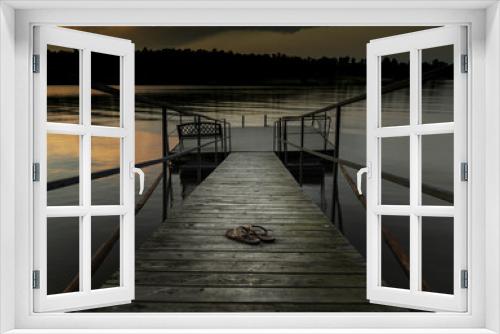 Fototapeta Naklejka Na Ścianę Okno 3D - Sandals on the dock at sunset