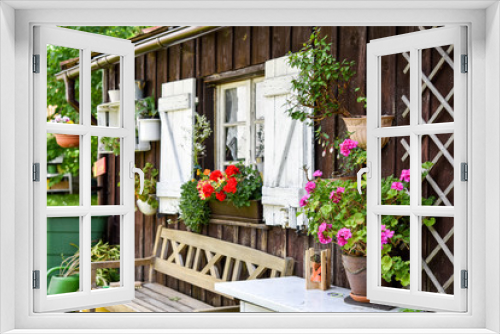 Fototapeta Naklejka Na Ścianę Okno 3D - Ein Garten mit Hütte mit Blumen im Sommer