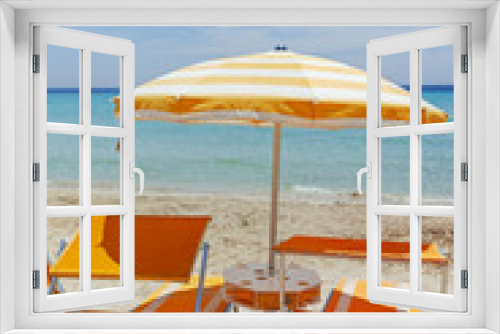 Fototapeta Naklejka Na Ścianę Okno 3D - Beach equipment, chairs and sun umbrella on white sandy beach with light blue sea water, beach vacation concept