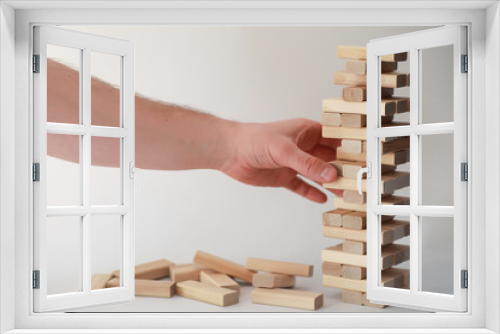 Fototapeta Naklejka Na Ścianę Okno 3D - Board game jenga tower of wood sticks