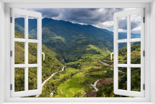 Fototapeta Naklejka Na Ścianę Okno 3D - Aerial drone view of huge rice terraces in a valley surrounded by tall mountains and low hanging cloud (Banaue)