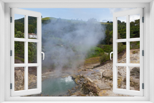 Fototapeta Naklejka Na Ścianę Okno 3D - Hot spring surrounded by volcanic terrain and mountainous landscape in Furnas, Azores, Portugal. Summer landscape of Azorean village on a cloudy day.