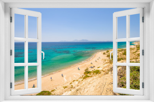Fototapeta Naklejka Na Ścianę Okno 3D - Beaches, Greece, Kos Island, Cap Helona: beautiful holiday setting on a secluded beach with umbrellas on the Greek Aegean Sea with turquoise waters and a picturesque bay and islands in the background