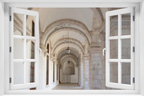 Walkway moving towards perspective through cloister and arches at Igreja e Convento da Graca in Lisbon, Portugal