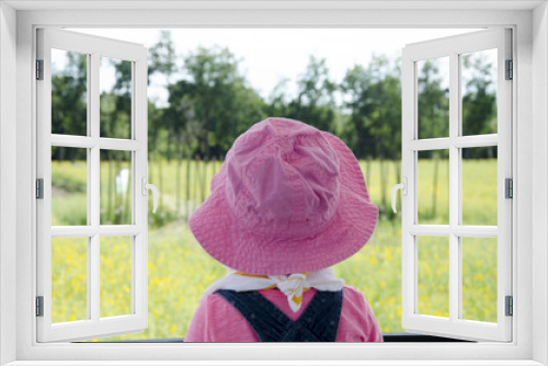 Fototapeta Naklejka Na Ścianę Okno 3D - Little girl in pink suit looking forward to the field