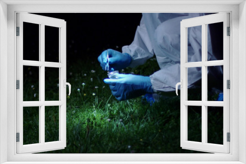 Fototapeta Naklejka Na Ścianę Okno 3D - Criminologist Looking for Evidence by Night