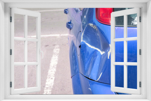 Fototapeta Naklejka Na Ścianę Okno 3D - Blue scratched car with damaged paint in crash accident or parking lot and dented damage of metal body from collision
