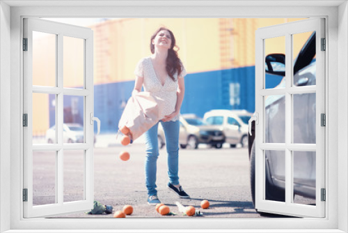 Woman with shopping near car