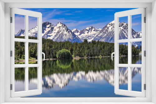 Fototapeta Naklejka Na Ścianę Okno 3D - The Grand Tetons of Wyoming are reflected perfectly in the still waters of Jackson Lake