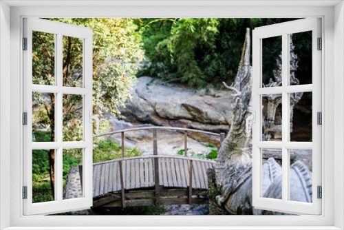 Fototapeta Naklejka Na Ścianę Okno 3D - The bridge in to Naga or dragon stairs leading to a footbridge over a river in a tropical forest focus bridge