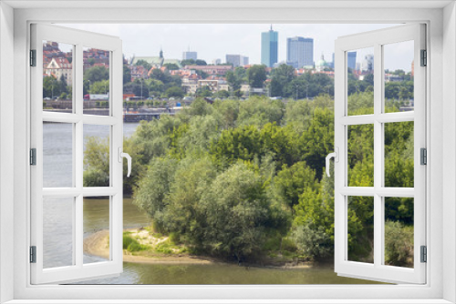 Fototapeta Naklejka Na Ścianę Okno 3D - City over the river. Warsaw over the Vistula. The old town is the Polish and Viennese Boulevards. High-rise buildings and historic