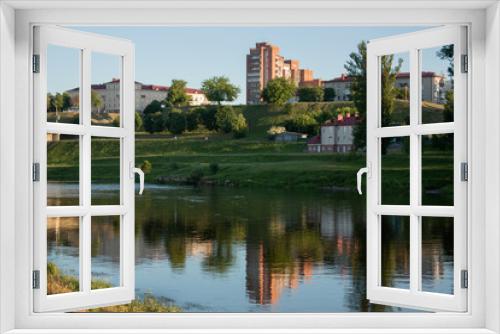 Fototapeta Naklejka Na Ścianę Okno 3D - Sights and views of Grodno. Belorussia. River Neman flowing through the city. Sunset and reflection in the water of buildings on the shore.