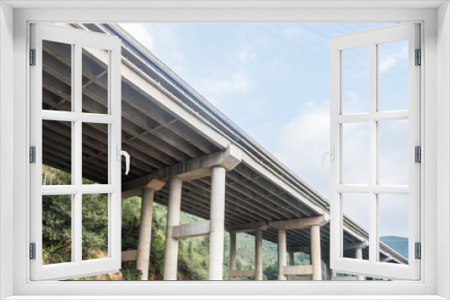 Fototapeta Naklejka Na Ścianę Okno 3D - highway bridge through green hills
