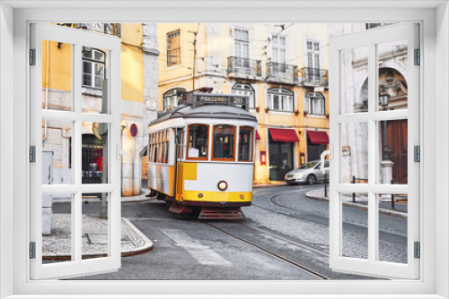 Fototapeta Naklejka Na Ścianę Okno 3D - Lisbon, Portugal. Vintage yellow retro tram on narrow bystreet