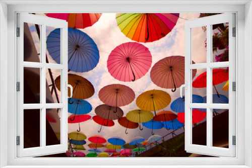 Fototapeta Naklejka Na Ścianę Okno 3D - street  decoration with bright umbrellas against the sky