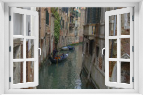 Fototapeta Naklejka Na Ścianę Okno 3D - Classic view of a narrow back cana with gondola and leaning buildings, Venice, Italty