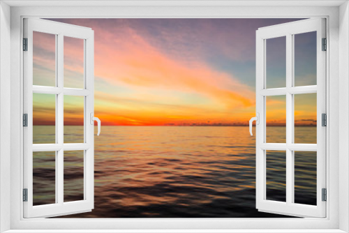 Fototapeta Naklejka Na Ścianę Okno 3D - Colorful sky as dawn breaks over calm waters in the Atlantic Ocean
