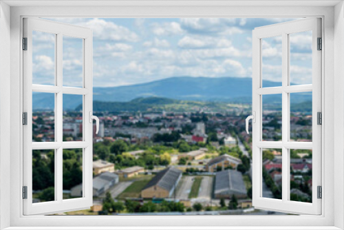 Fototapeta Naklejka Na Ścianę Okno 3D - Panoramic view of the big city in the mountains. The lady looks so tiny