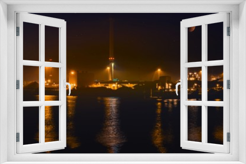 Fototapeta Naklejka Na Ścianę Okno 3D - View of cargo port at night . View of the loading in the sea port  . Cargo area on night time with reflections on water 