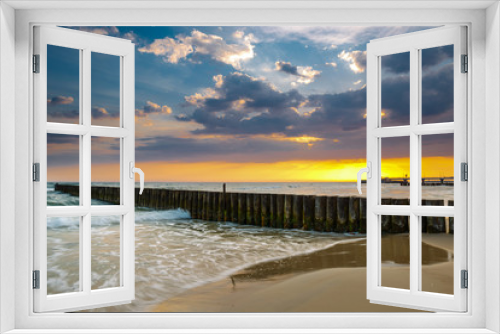 Fototapeta Naklejka Na Ścianę Okno 3D - Sunset on the beach with breakwater, long time exposure