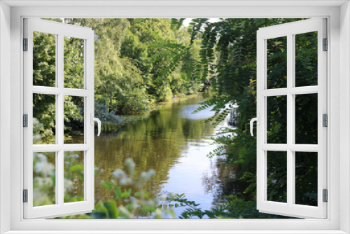 Fototapeta Naklejka Na Ścianę Okno 3D - Scenic view of the river Alster and lush greenery surrounding it in Eppendorf, Hamburg