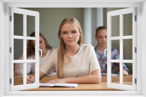 student girls are sitting at a Desk