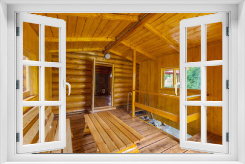 Fototapeta Naklejka Na Ścianę Okno 3D - The bathhouse is made of a wooden frame with wide comfortable benches and stairs to the pool