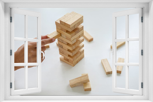 Fototapeta Naklejka Na Ścianę Okno 3D - Hand of business people planning, risk and strategy in business.Businessman gambling placing wooden block on a tower.