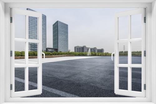 Fototapeta Naklejka Na Ścianę Okno 3D - Panoramic skyline and modern business office buildings with empty road,empty concrete square floor