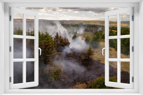 Fototapeta Naklejka Na Ścianę Okno 3D - Aerial drone view of a smouldering wildfire in Wales, UK