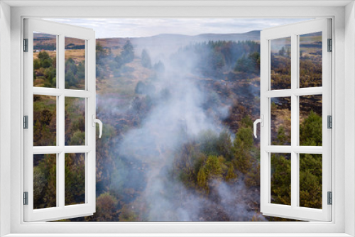Fototapeta Naklejka Na Ścianę Okno 3D - Aerial drone view of a wildfire in a grass and forested area