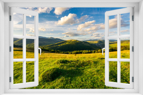 Fototapeta Naklejka Na Ścianę Okno 3D - beautiful countryside in the evening. fluffy clouds over the mountains in the distance. calm and relaxing scene before sunset