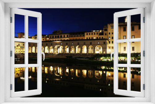 night landscape of Florence or Firenze city and the Arno river Italy