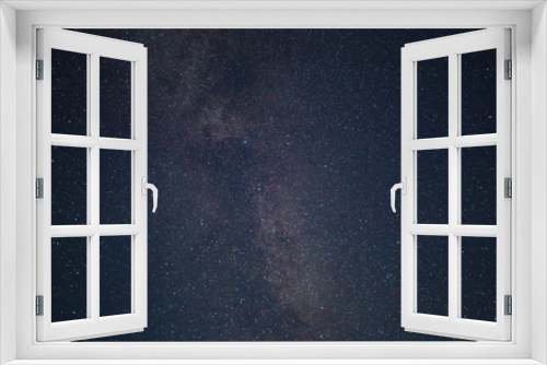 Fototapeta Naklejka Na Ścianę Okno 3D - Night dark blue starry sky. Milky way galaxy with colorful bright shining stars,  long exposure photograph, with grain.