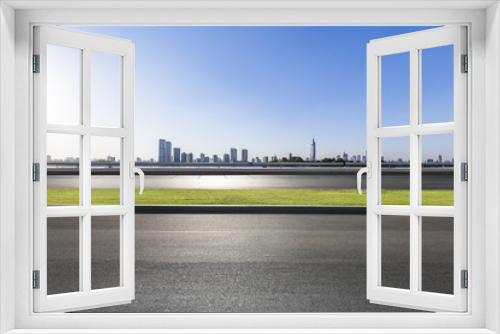 Fototapeta Naklejka Na Ścianę Okno 3D - Panoramic skyline and modern business office buildings with empty road,empty concrete square floor