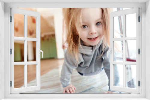 Little girl crawls on her hands