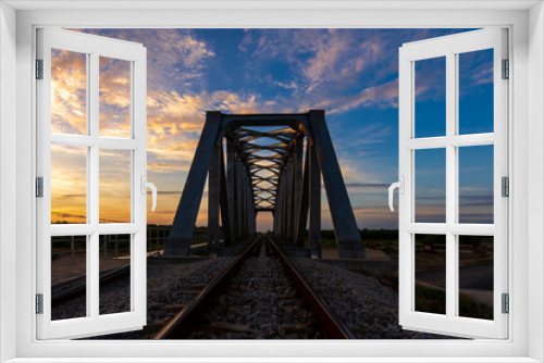 Fototapeta Naklejka Na Ścianę Okno 3D - Railway metal bridge on sunset sky background