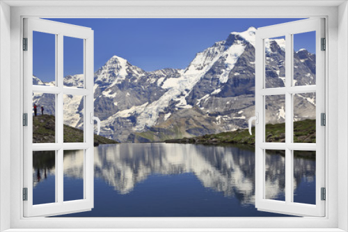 Fototapeta Naklejka Na Ścianę Okno 3D - Summer in the Swiss Alps, Murren area, overlooking the Monch and Jungfrau mountains reflected in Grauseewli Lake, Canton of Bern, Switzerland, Europe