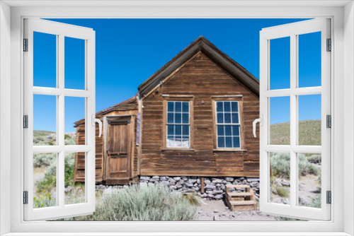 Fototapeta Naklejka Na Ścianę Okno 3D - Abandoned rustic wood-sided home in the ghost town of Bodie, California