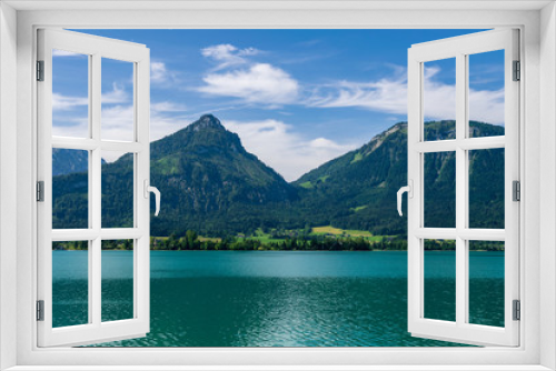 Fototapeta Naklejka Na Ścianę Okno 3D - Lake called Wolfgangsee in Austria with Mountains in the Background and Clouds on the Sky