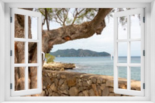 Fototapeta Naklejka Na Ścianę Okno 3D - Natural stone wall on the promenade from the resort of Cala Millor with a view of the Mediterranean Sea and the hills on the Spanish Balearic island of Mallorca
