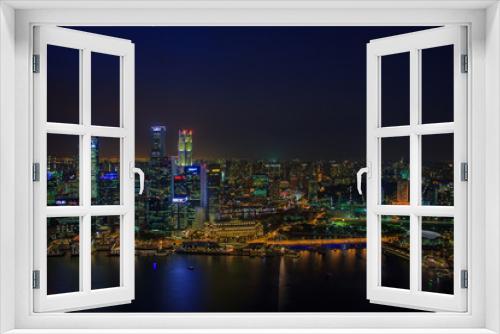 Fototapeta Naklejka Na Ścianę Okno 3D - SINGAPORE, January 19 2014 - Singapore Skyline at Night viewed from Ku De Ta Restaurant in Marina Bay Sands hotel