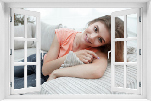 young female student relaxing at home on the couch.